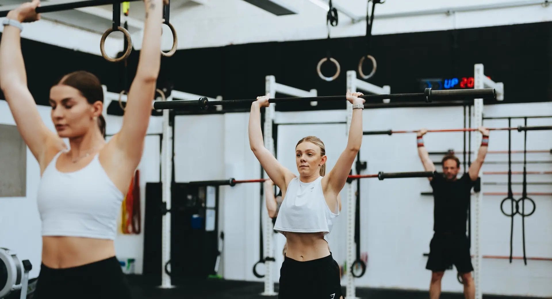Members stretch with bar